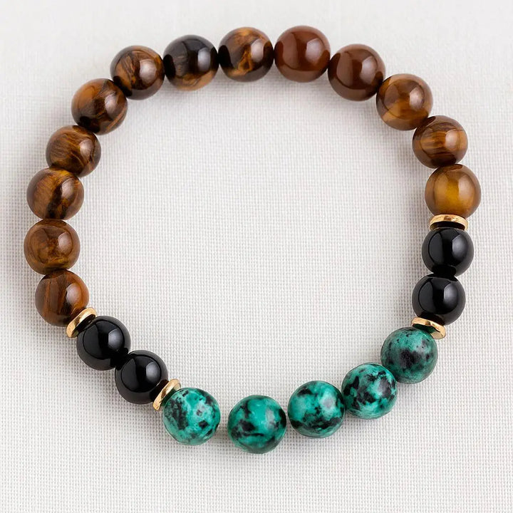 Pulseira de pedras naturais combinando Olho de Tigre, Turquesa Africana e Ônix Negra, ideal para complementar sua prática de meditação e proteção energética.